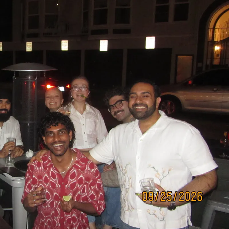 Friends gathered around a patio table at night